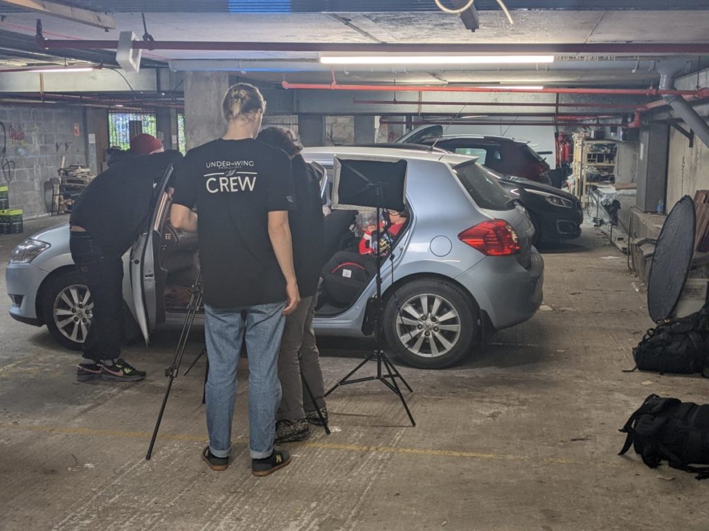 Filming a scene in an underground carpark where someone experiencing homelessness is living in a car.